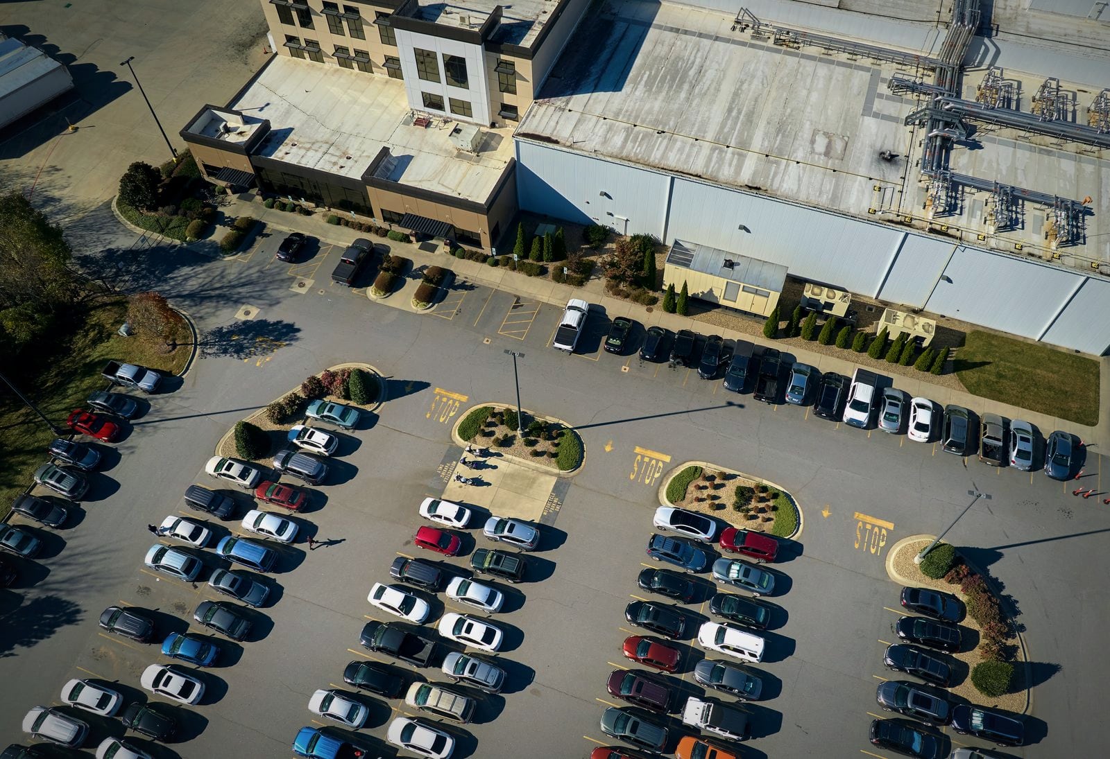 A fleet yard seen from above, rows of cars parked and ready to go out
