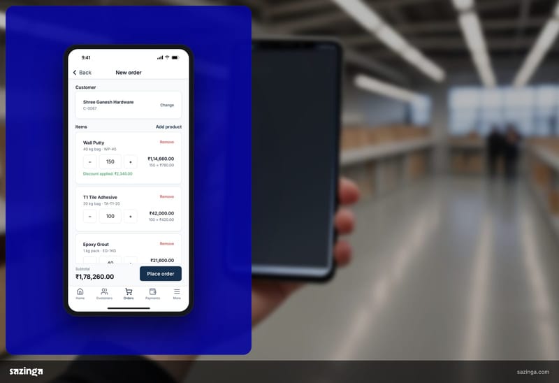 A sales rep in a warehouse aisle checking the order screen in Sazinga Field on a phone, where currency and dates should follow the company settings.
