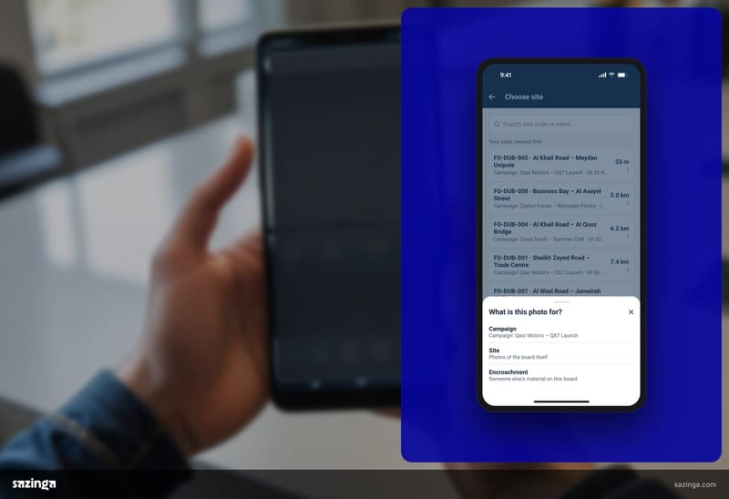 A field user in a print room scrolling the list of boards assigned to them in the Sazinga AdBoard field app on a phone.
