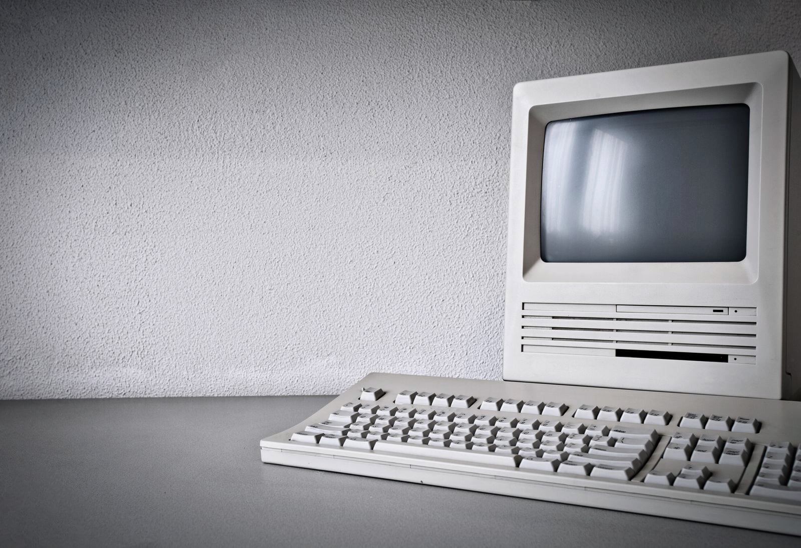 An old desktop computer and keyboard on a desk, the system the business still runs on